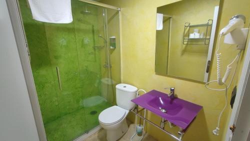 a bathroom with a purple sink and a shower at Hotel Aro'S in Casas Ibáñez