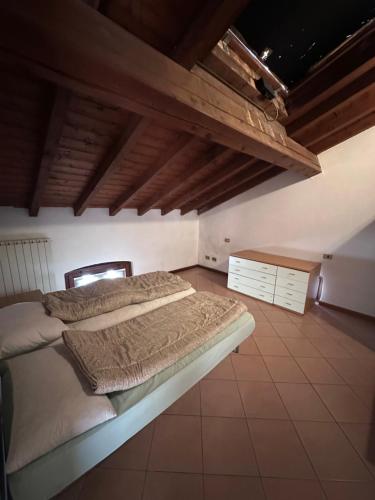 a bedroom with a bed in a room with wooden ceilings at Dante 12 Flat in Cremona