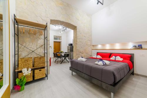 a bedroom with a large bed with red pillows at Salerno Mare e Luci Suite in Salerno