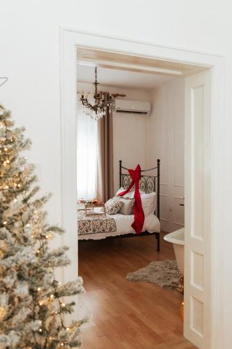 a bedroom with a bed and a christmas tree at Chic&Vrdnik in Vrdnik