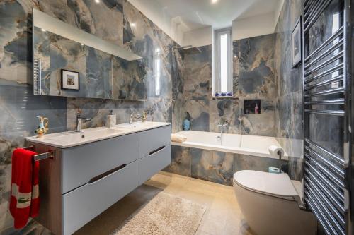 a bathroom with a sink and a tub and a toilet at Pink Moon Private Luxury Villa Secluded Garden 5 Bedroom 4 en suite Bathrooms with Private Pool CAT 6 WiFi Close to Beach in Fontane Bianche