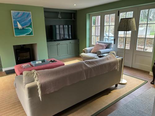 a living room with a couch and a chair at Riverside Cottage in Marlborough