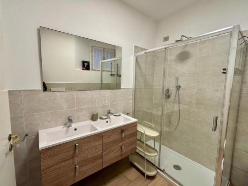 a bathroom with a sink and a shower at Varenna Boulevard in Varenna