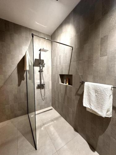 a bathroom with a shower with a glass door at Green Heaven Studio in Bois Chéri