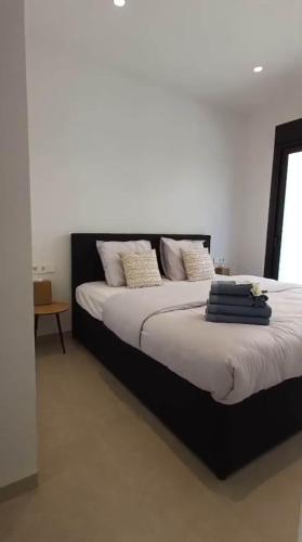 a bedroom with a large bed with a black headboard at Villa Hermana Major Luxury Villa in Las Flamencas in San Javier
