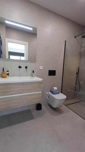 a bathroom with a tub and a toilet and a mirror at Villa Hermana Major Luxury Villa in Las Flamencas in San Javier