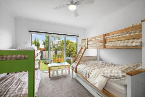a bedroom with a bunk bed and a window at Guesthouse on Grampian in Cowes
