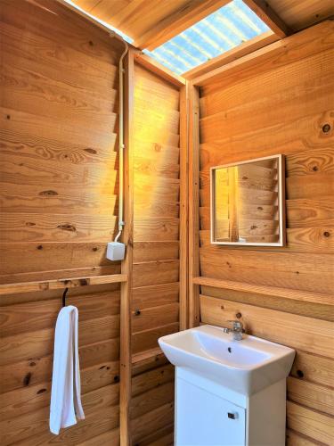 a bathroom with a white sink and a mirror at Parque da Mina in Monchique