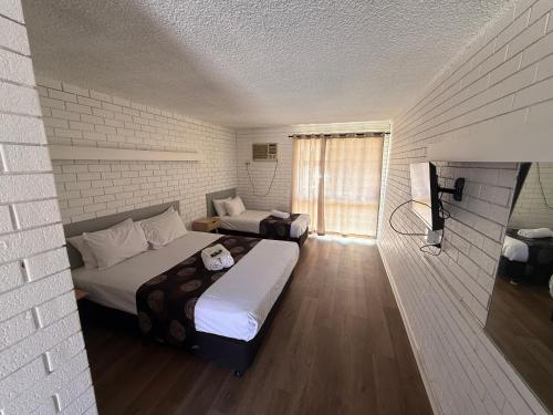 a room with two beds and a television in it at Budget Motel in Midland Junction