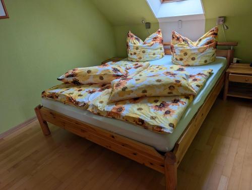 a bedroom with a twin bed with pillows on it at Ferienwohnung-Sonnenterrasse in Malchow