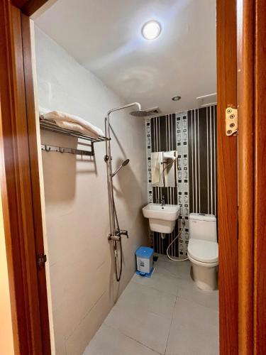 a bathroom with a toilet and a sink at HOÀNG ĐẾ motel in Chau Doc