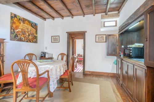 a kitchen and dining room with a table and chairs at Casas da Torre Medieval - by Proguest in Refoios do Lima