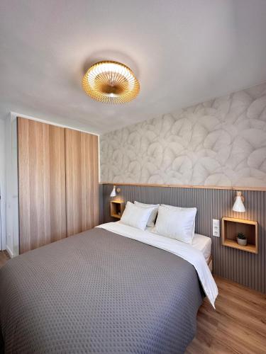 a bedroom with a large bed with a ceiling at Casa Luxemburgo in Torrevieja