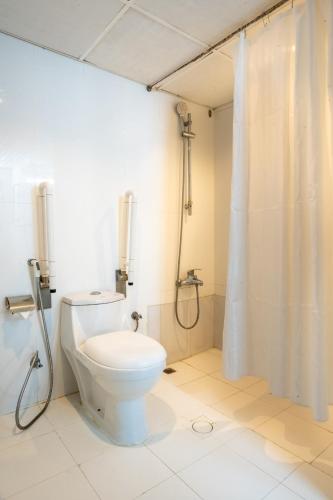 a bathroom with a toilet and a shower at Regal Peninsula Hotel Formerly New Peninsula Hotel Ghubaiba Bus Station Bur Dubai in Dubai