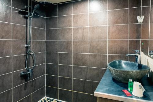 a bathroom with a sink and a shower at Auberge de la Paix in Briançon