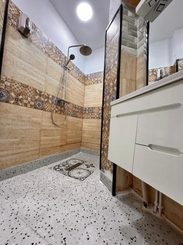 a bathroom with a shower and a tile floor at Dar el bahdja in Sidi MʼHamed
