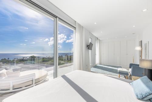 a bedroom with a bed and a view of the ocean at Villa Eliseo - private pool and sea views I 2400 in San Roque