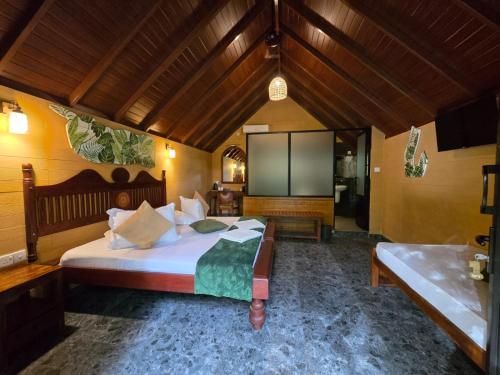 a bedroom with a bed and a flat screen tv at Veraima Kandy in Kandy