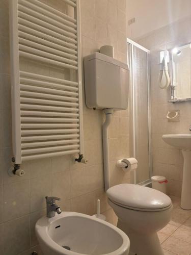 a small bathroom with a toilet and a sink at Hotel San Paolo in Varazze