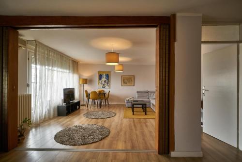 a living room with a door open to a living room at 7 Heaven in Belgrade
