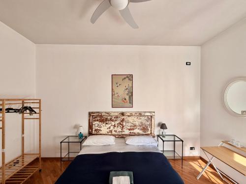 a bedroom with a bed and a ceiling fan at Santo Spirito in Arezzo