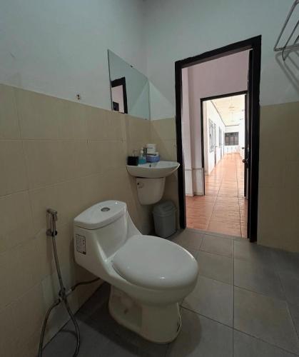 a bathroom with a toilet and a sink at Apatuxay Vientiane Hostel in Vientiane