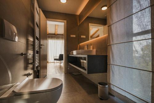 a bathroom with a tub and a sink at Deluxe Villa with heated pool in Brtonigla