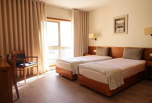 Llit o llits en una habitació de Hotel dos Loios