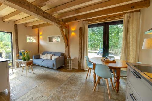 a kitchen and living room with a table and a couch at Bed & Breakfast De Tol in Sint Annaland