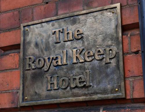 a metal sign on the side of a brick building at The Royal Keep Hotel in Dudley in Dudley