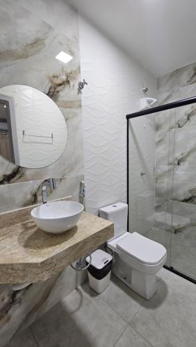 a bathroom with a sink and a toilet at Hotel Almany in Palmas