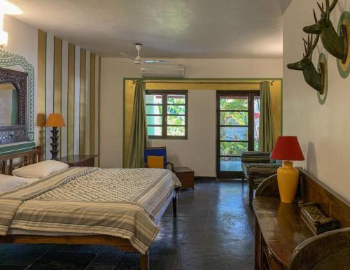 a bedroom with a bed and a couch and windows at Casa Baga in Baga