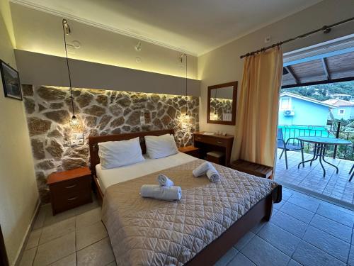 a bedroom with a bed with two towels on it at Dimarion Villas in Agios Nikitas