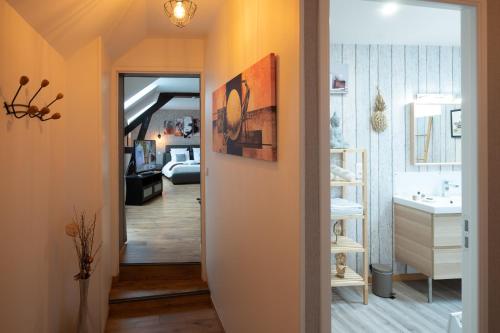a hallway leading to a bathroom with a sink at Ô Spa Champenois in Écueil