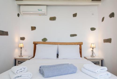 a bedroom with a bed with towels on it at Efthymia apartments in Faros