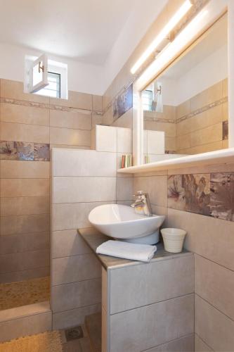 a bathroom with a sink and a mirror at Efthymia apartments in Faros