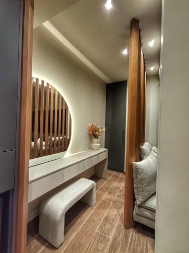 a dressing room with a bench and a chair at Olive City Suites in Larisa