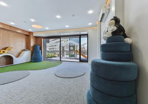 a childs room with a blue staircase with a stuffed animal at Modern Spaces U-Tower in Tashkent