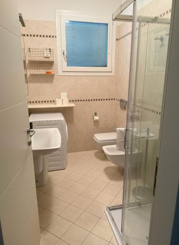a bathroom with a toilet and a sink and a shower at Appartamento Solution Garibaldi in Marina di Ravenna