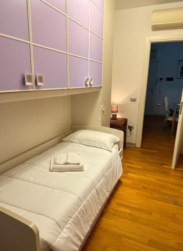a bedroom with a bed with a towel on it at Appartamento Solution Garibaldi in Marina di Ravenna