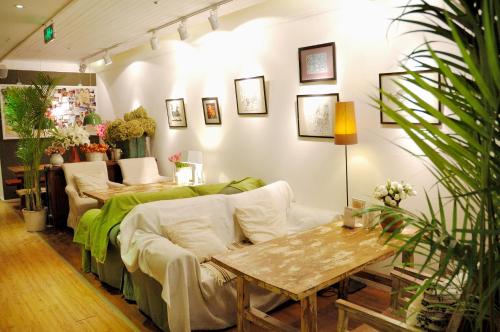 a living room with a couch and a table at Peking Garden Youth Hostel in Beijing