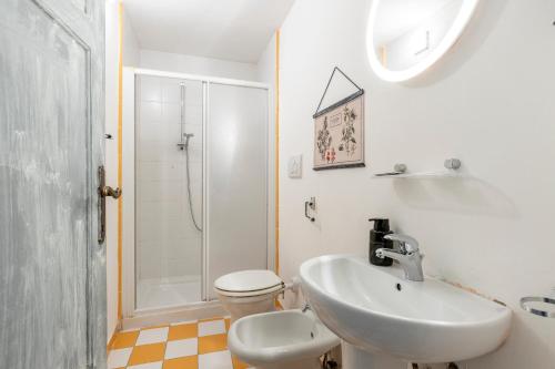 a bathroom with a sink and a toilet and a shower at Lucca Charm in Lucca