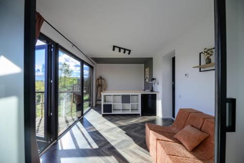 a living room with a couch and a table at Evergreen Retreat in Râșca