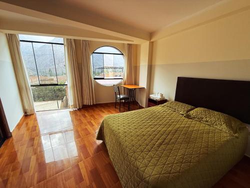 a bedroom with a bed and a large window at Apart La Merced in Caraz