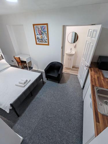 a small room with a bed and a sink at Rose Studio - Self Contained Studio Flat in Oxford
