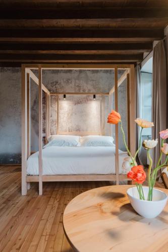 a bedroom with a bed and a wooden table at Locanda Scotti in Paladina