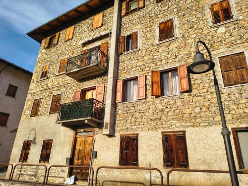 a large stone building with windows and a street light at Ciasa Cadorina - Relax nelle Dolomiti in Pelos