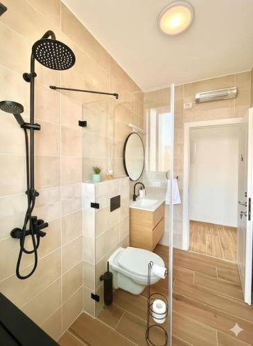 a bathroom with a shower and a toilet and a sink at The Peleg Tal Unit - היחידה בפלג טל in Dafna