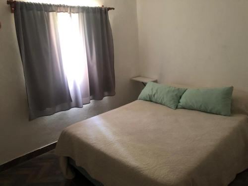 a small bedroom with a bed with a window at Lujan de cuyo 2 in Ciudad Lujan de Cuyo