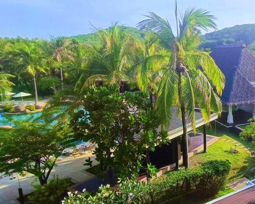 an aerial view of a resort with a pool and palm trees at BB Luxury Villa in Phuket